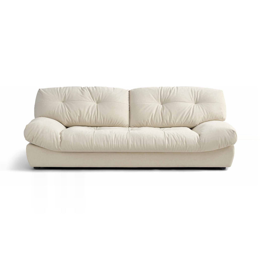 A cream-colored, two-seater sofa with tufted cushions is presented on a white background.