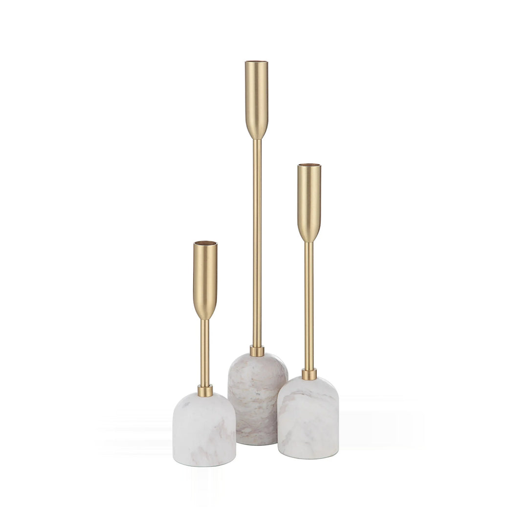Three white and gold candle holders of varying heights are arranged on a white background.