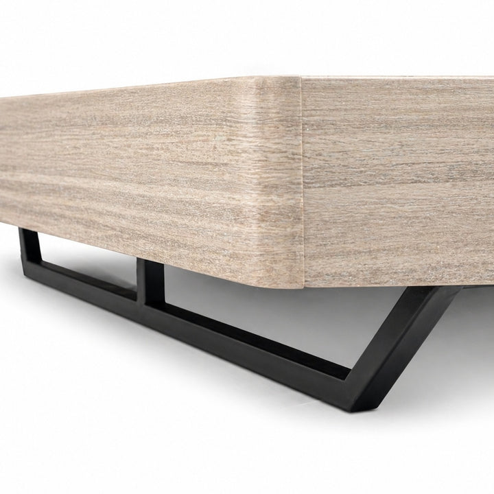 Close-up of a light beige wood-grain headboard corner supported by an angular black metal frame.