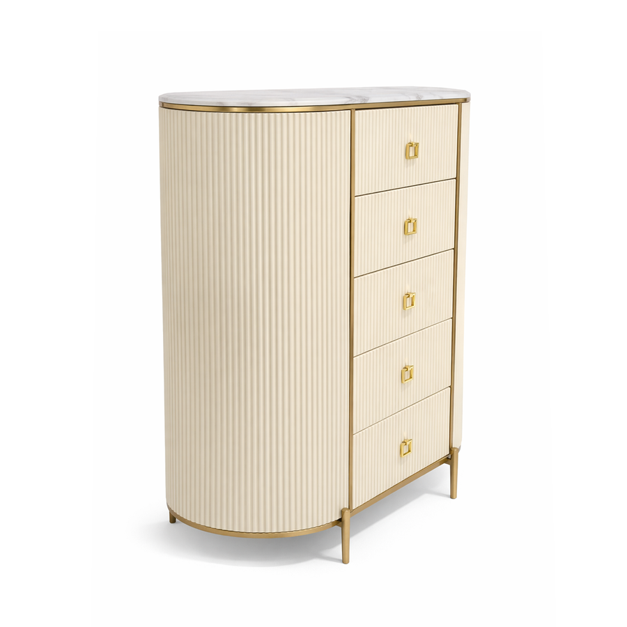 Cream fluted storage chest with curved side, white marble top, gold trim, and five drawers.