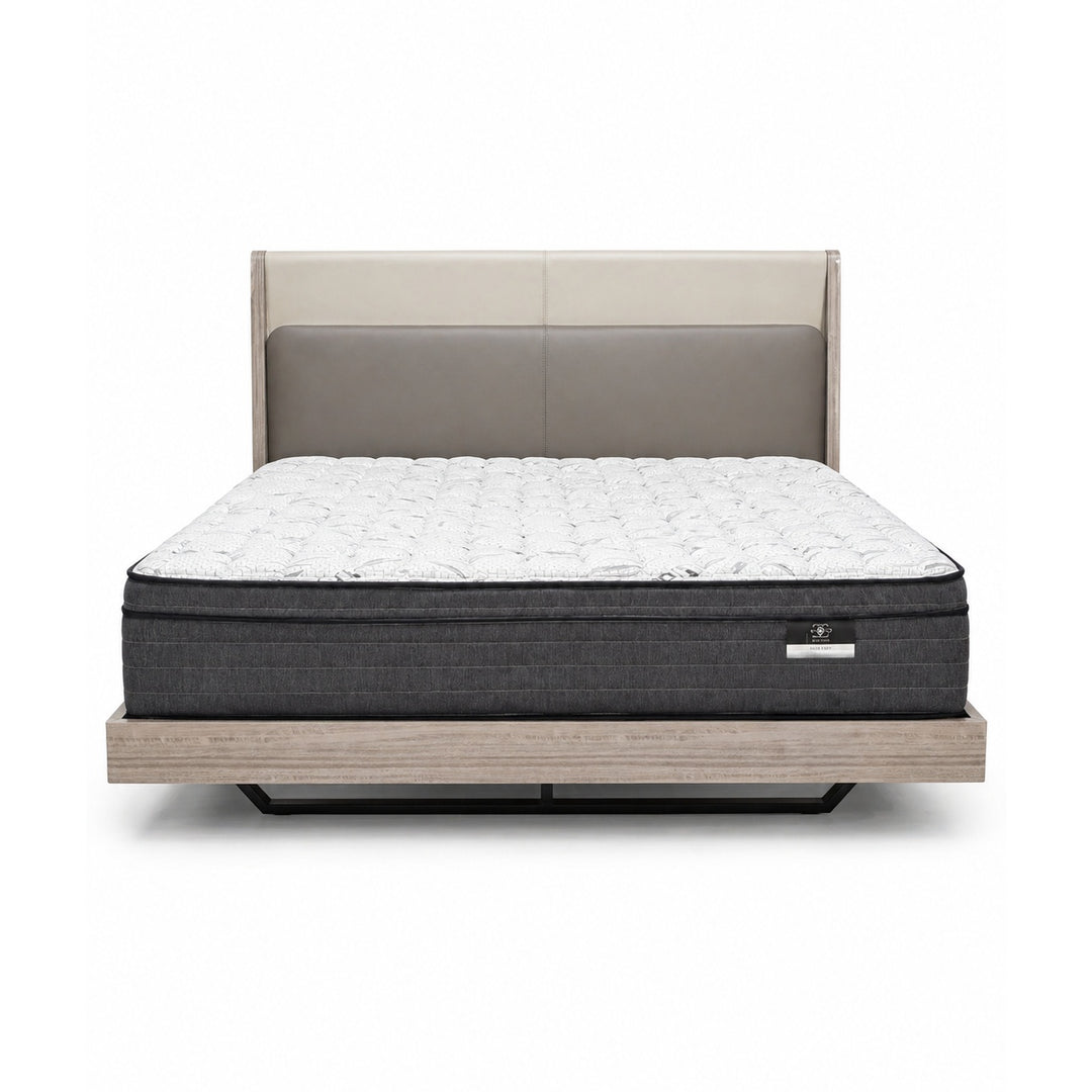 Front view of a bed with a two-tone beige and taupe upholstered headboard, white quilted mattress, and light wood platform base.