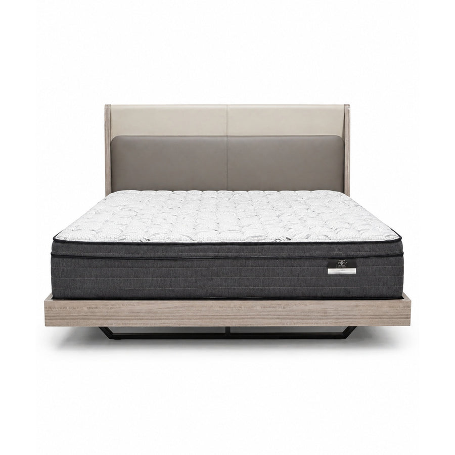 Front view of a bed with a two-tone beige and taupe upholstered headboard, white quilted mattress, and light wood platform base.