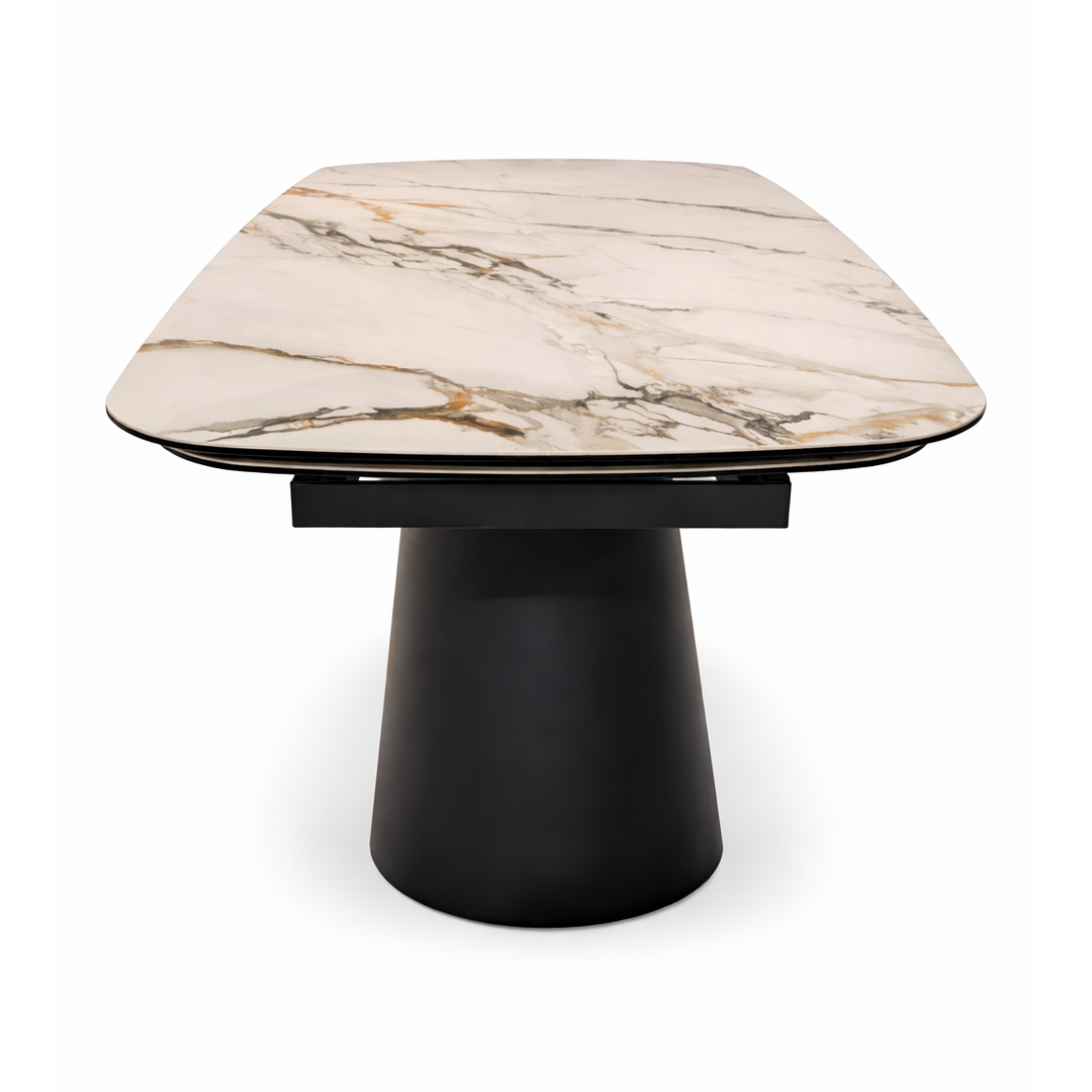 Cream marble dining table top with gold and grey veining on a matte black pedestal base.