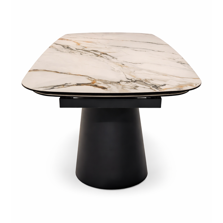 Cream marble dining table top with gold and grey veining on a matte black pedestal base.