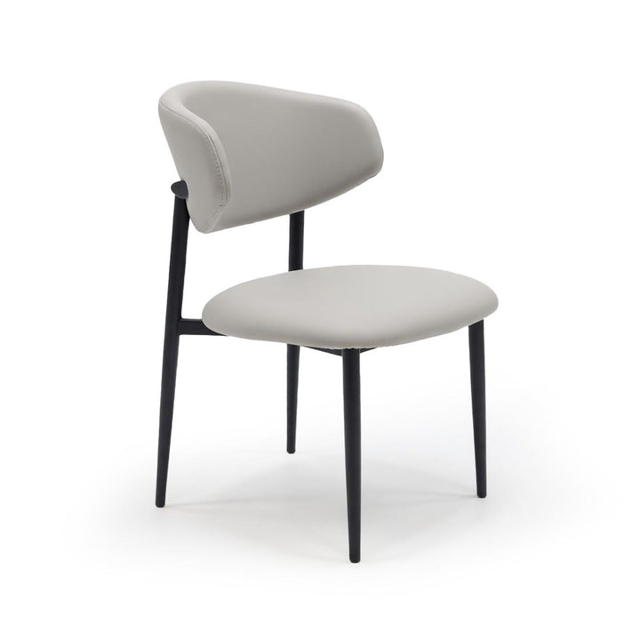 Light grey upholstered dining chair with curved backrest and black metal legs.