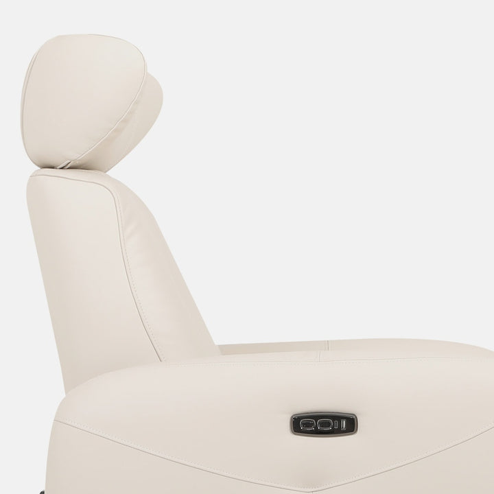 Close-up of a bisque leather sofa chair on a white background, showcasing the headrest and side controls.