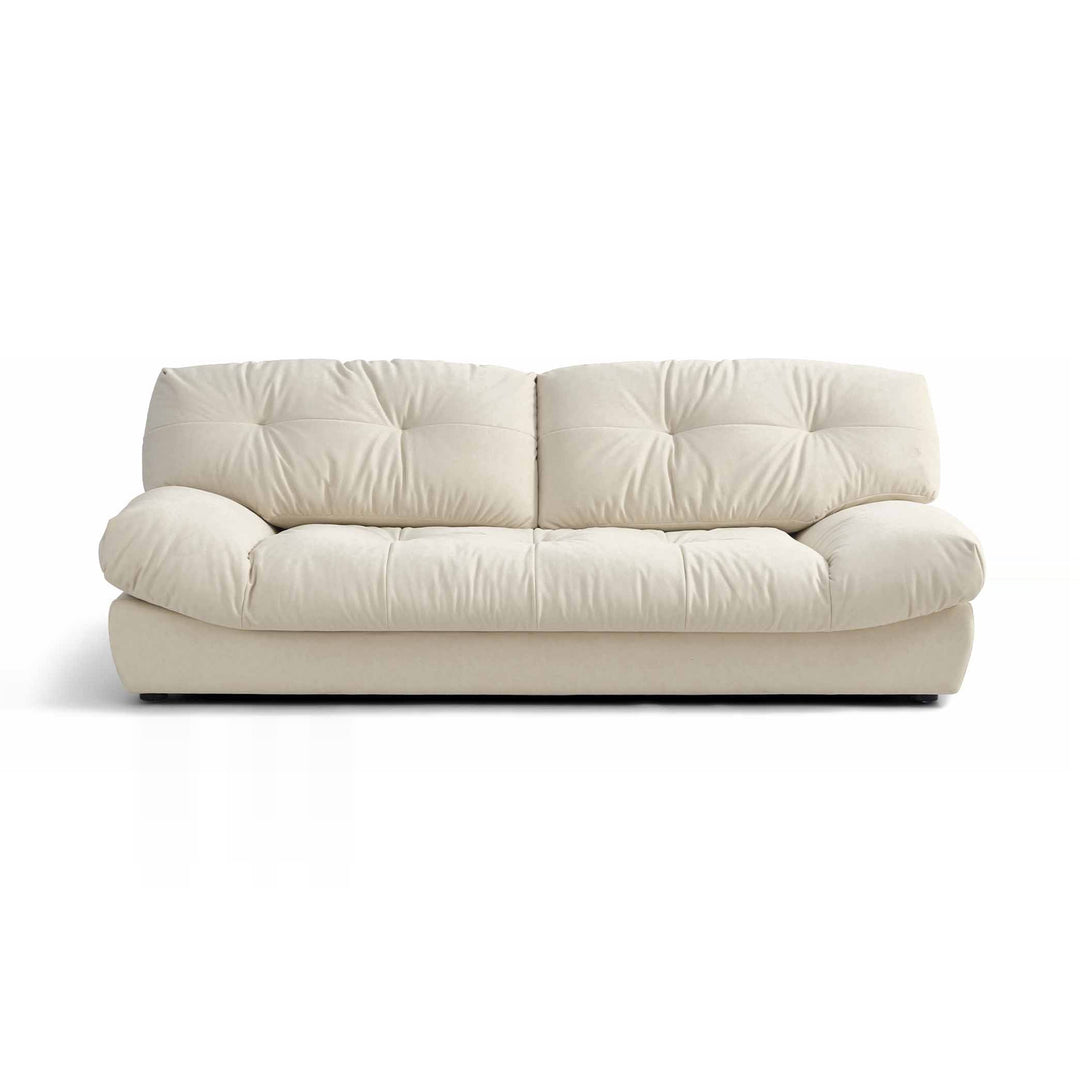 A cream-colored, two-seater sofa with tufted cushions is presented on a white background.