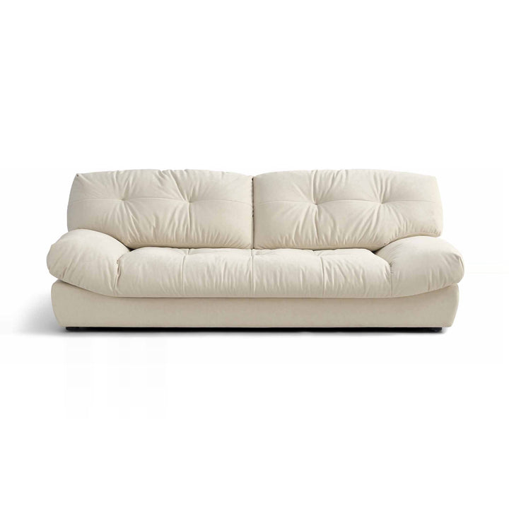 A cream-colored, two-seater sofa with tufted cushions is presented on a white background.