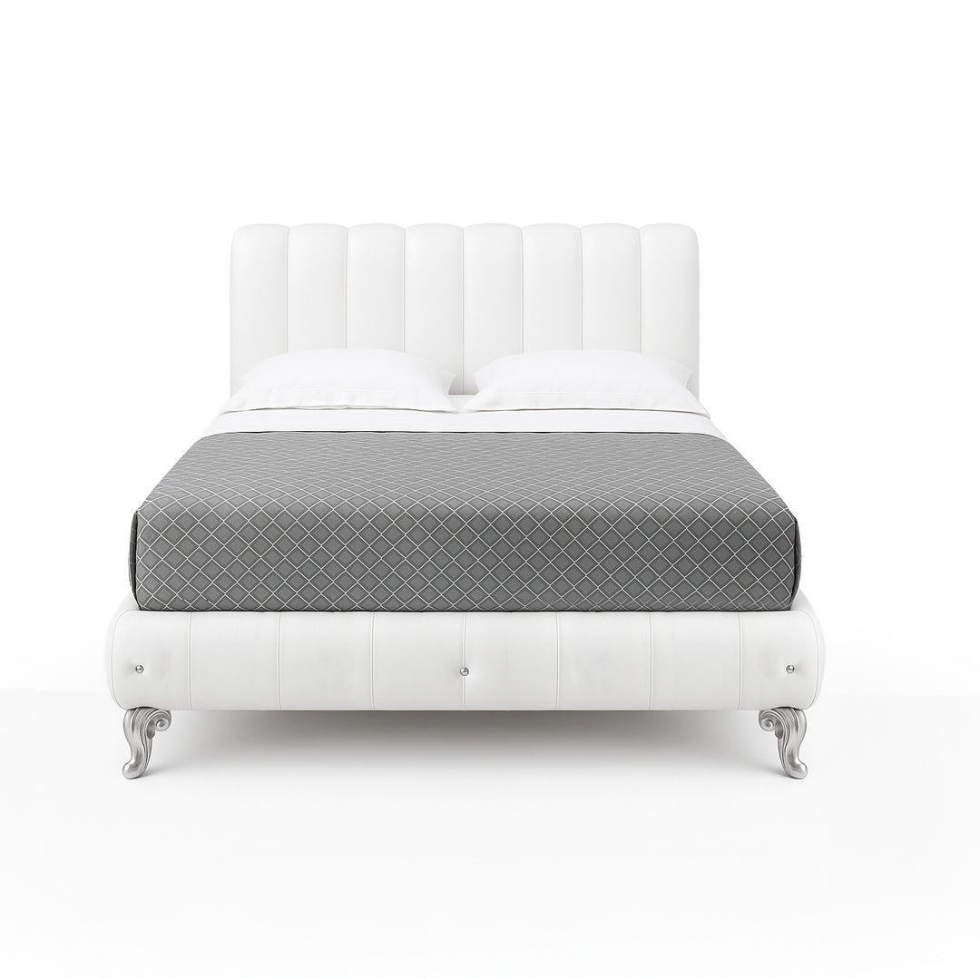 A white leather bed with a tufted headboard and footboard, silver legs, and a gray patterned blanket, set against a white background.