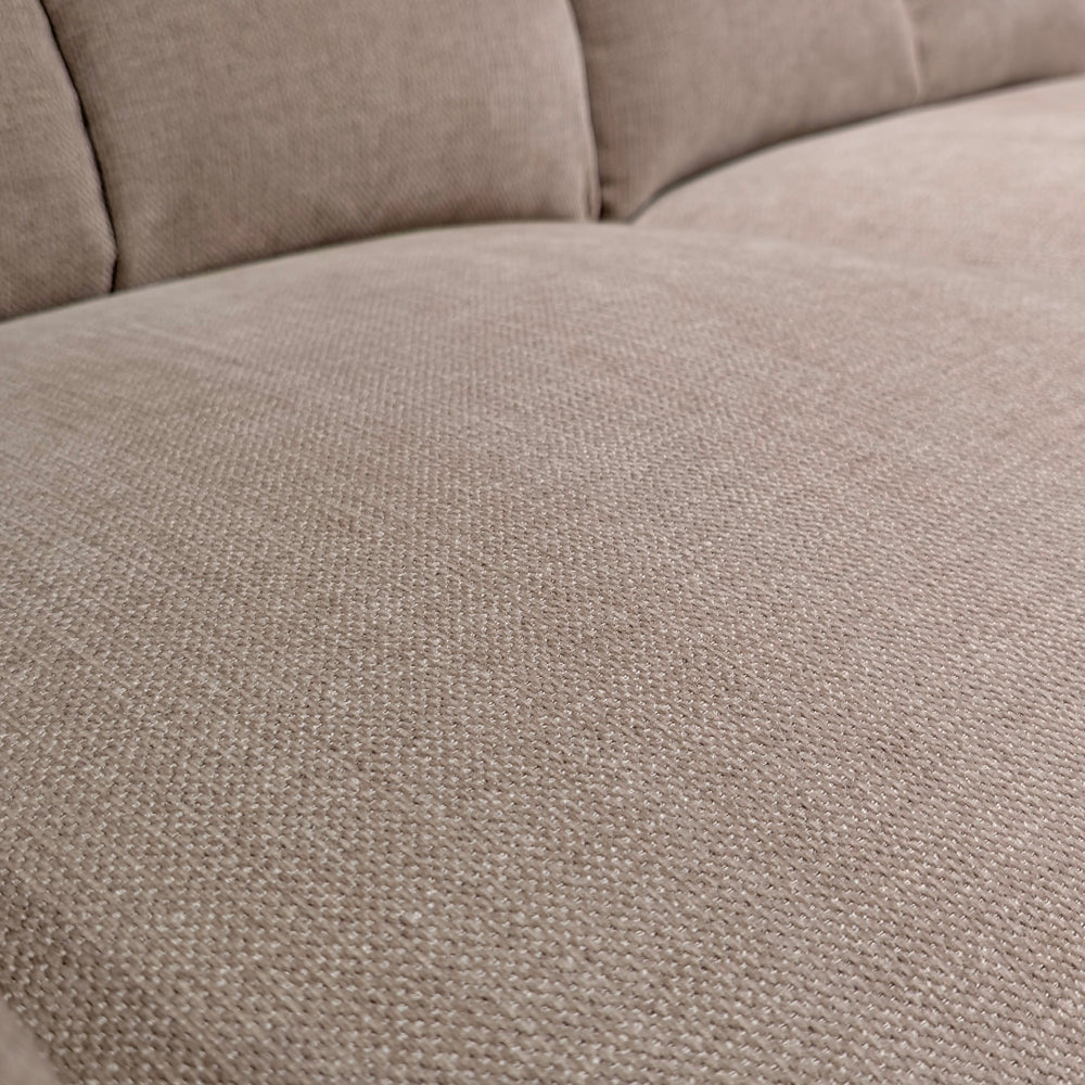 Close-up of a beige fabric sofa seat showing the woven texture and plush cushions.