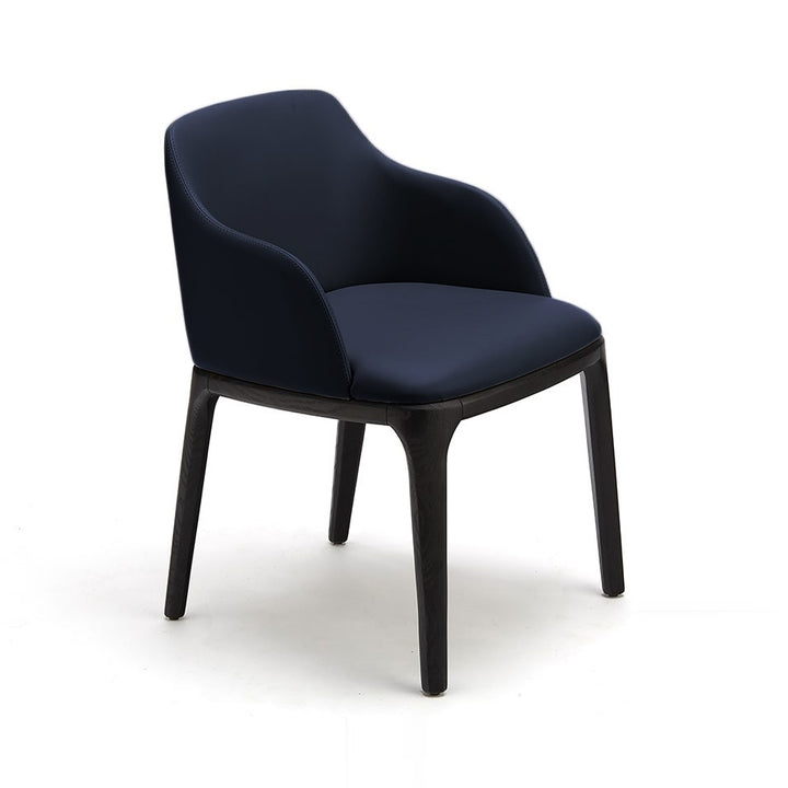 A navy blue upholstered armchair with dark wood legs is isolated on a white background.