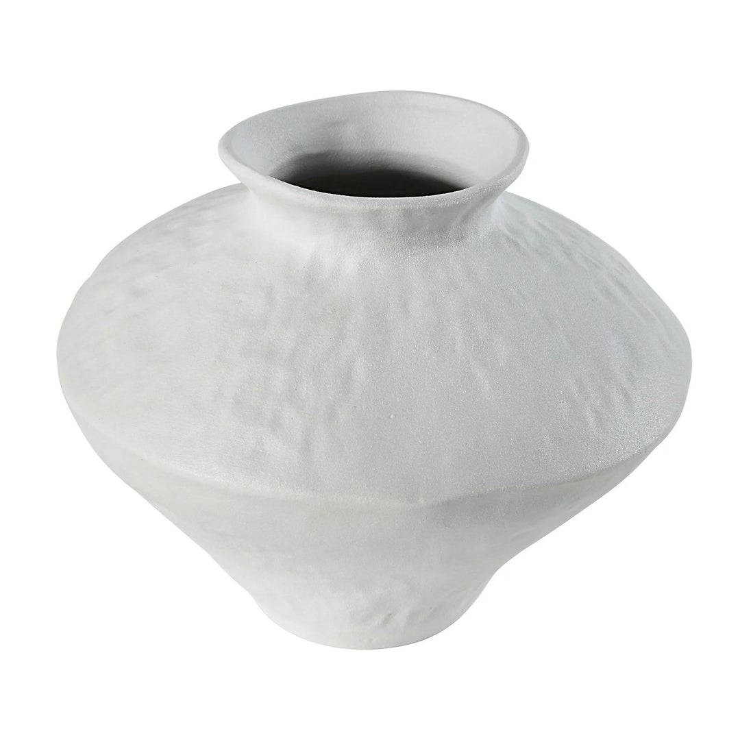 Close-up of a white ceramic vase with a textured surface, isolated on a white background.