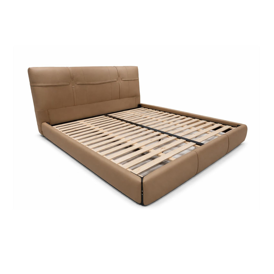 Tan leather platform bed frame with exposed wooden slats and a three-panel tufted headboard.