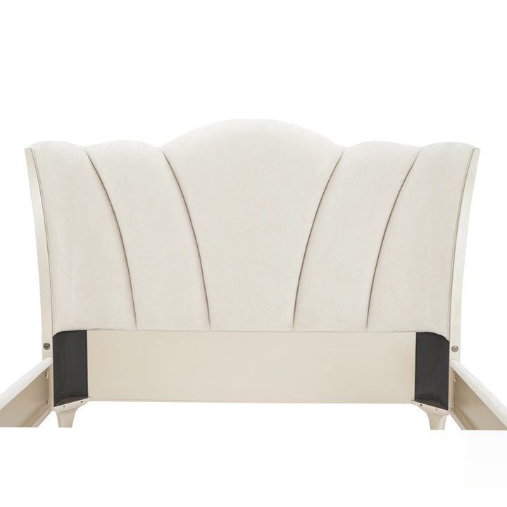 Ivory upholstered headboard with a scalloped design isolated on a white background.