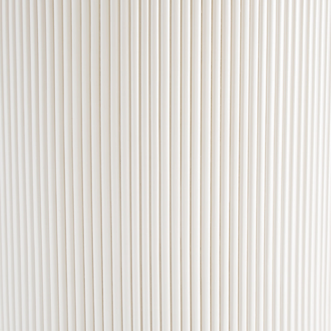 Close-up of a white corrugated material surface with vertical lines.