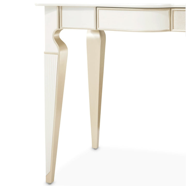 Close-up of a white and gold desk with drawers on a white background.