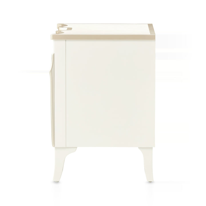 A white and tan-colored nightstand with curved legs and a simple design, presented on a white background.
