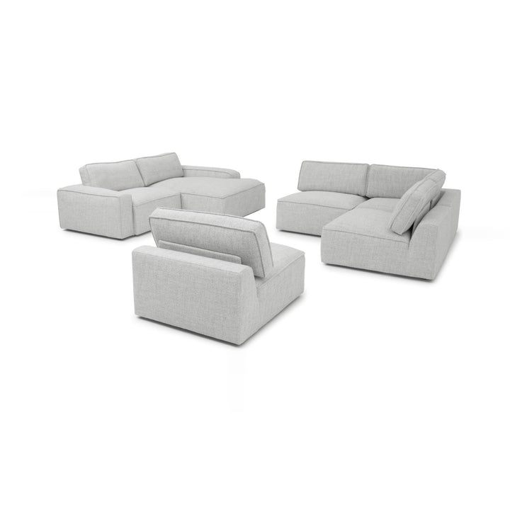 A light gray modular sofa set is arranged on a white background, featuring sectional pieces and an armchair.
