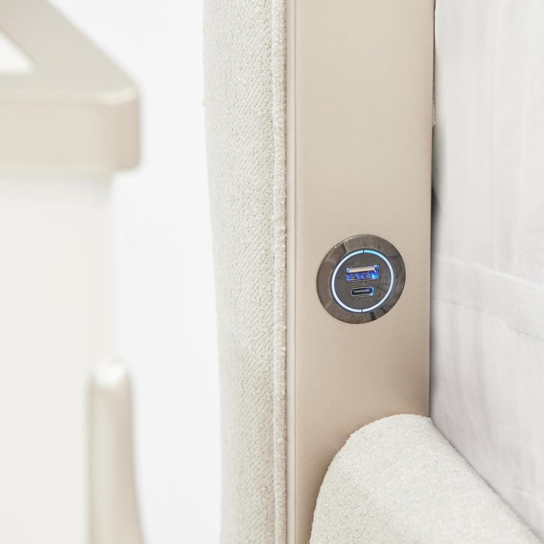 Close-up of a headboard with a fabric finish and integrated USB and USB-C charging ports.