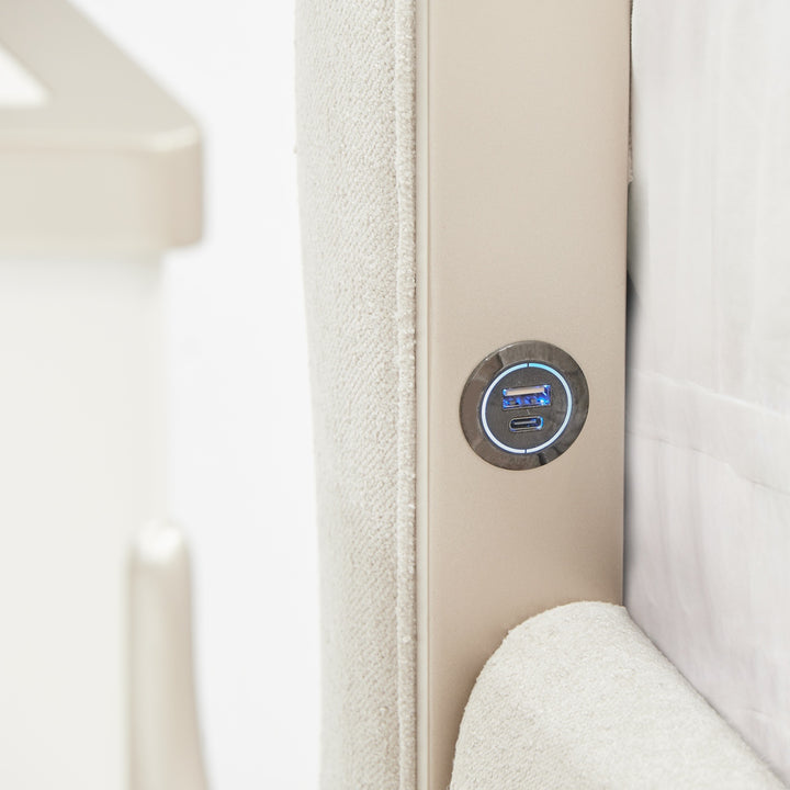 Close-up of a headboard with a fabric finish and integrated USB and USB-C charging ports.
