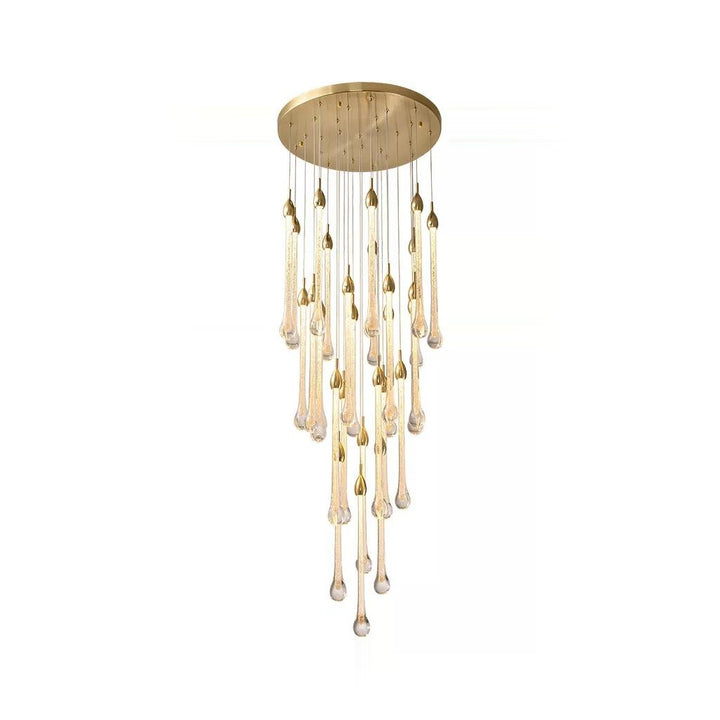 A gold chandelier with raindrop-shaped glass pendants hangs against a white background.
