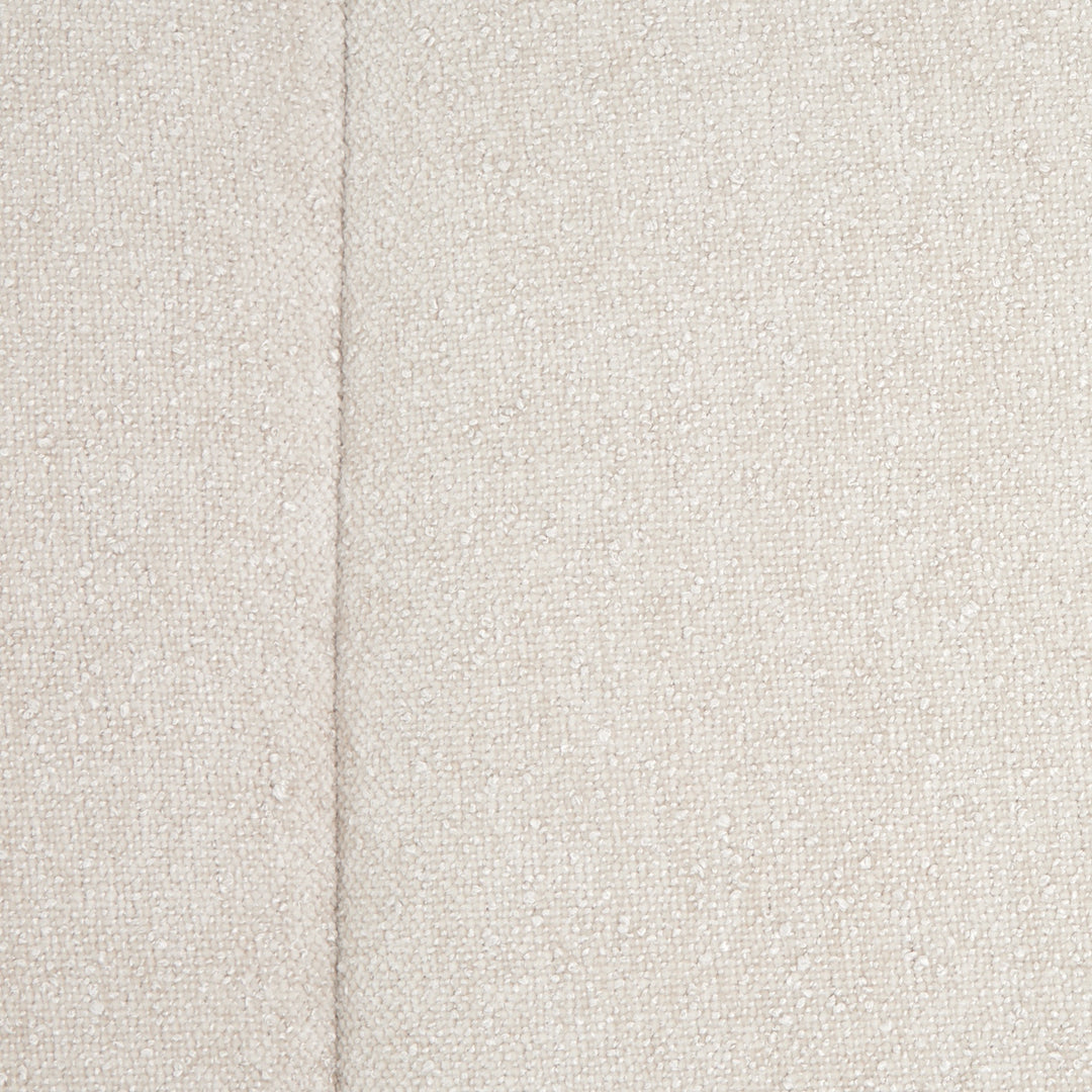 Close-up view of a textured, off-white fabric, likely a furniture upholstery material, with a seam visible.
