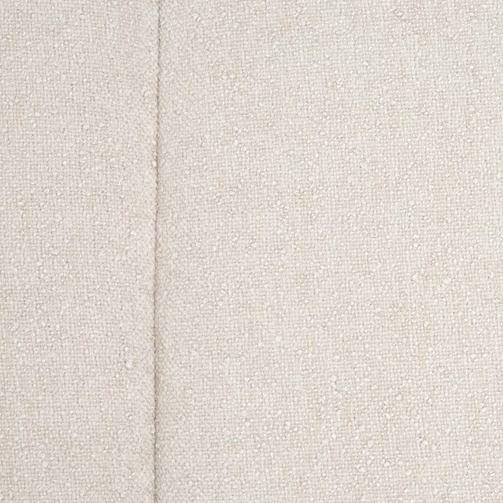 Close-up view of a textured, off-white fabric, likely a furniture upholstery material, with a seam visible.