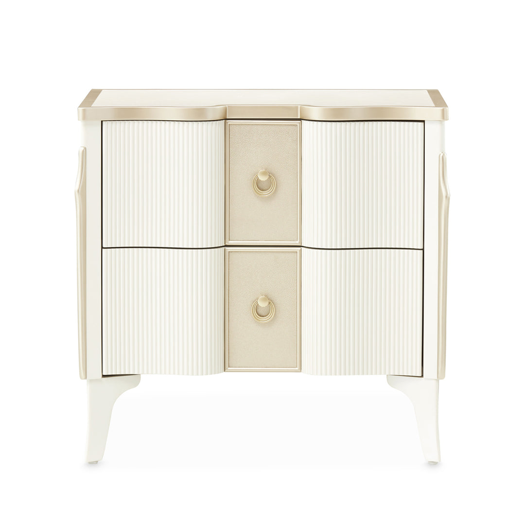 A two-drawer nightstand with a cream and gold finish, photographed on a white background.