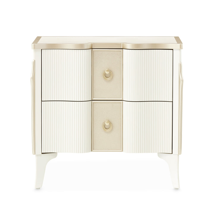 A two-drawer nightstand with a cream and gold finish, photographed on a white background.