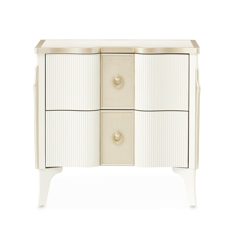 A two-drawer nightstand with a cream and gold finish, photographed on a white background.