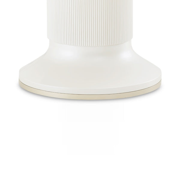 Close-up of the base of a white furniture piece with a ribbed section, isolated on a white background.