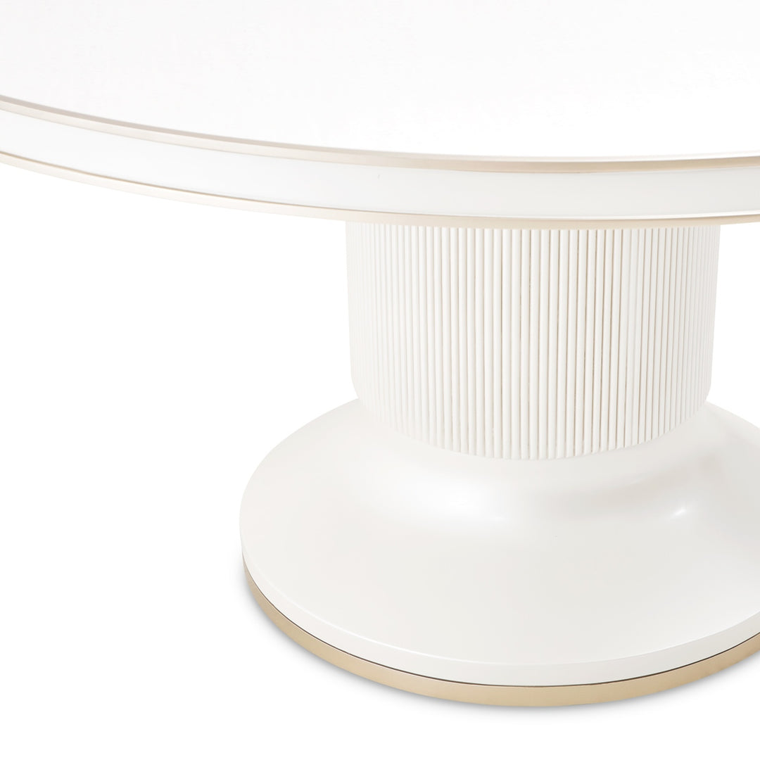 A close-up of a white and gold round table on a white background, showcasing the table's design and materials.