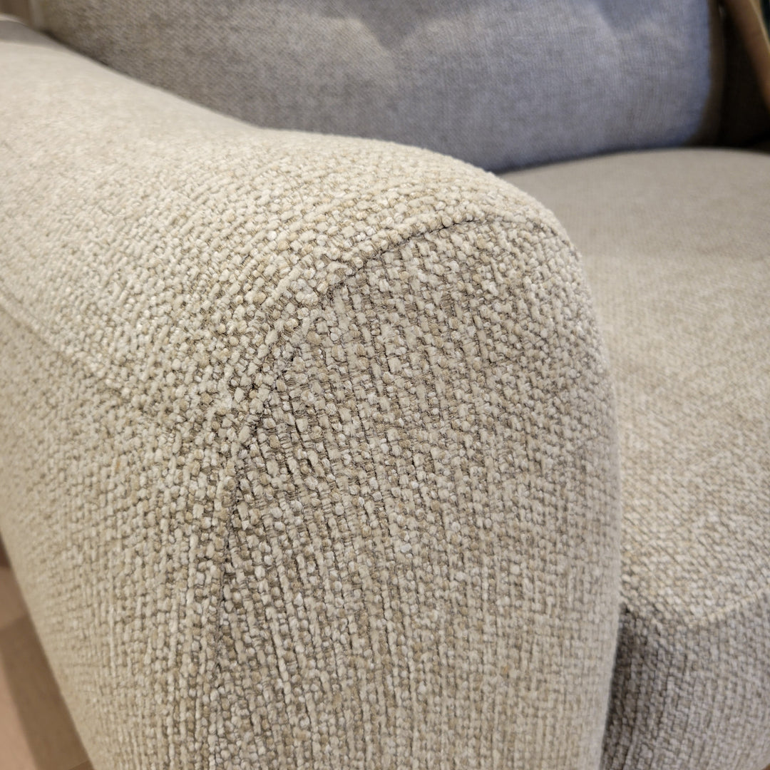 Close-up shot showcasing the texture of a couch's armrest, emphasizing the fabric's weave and color.