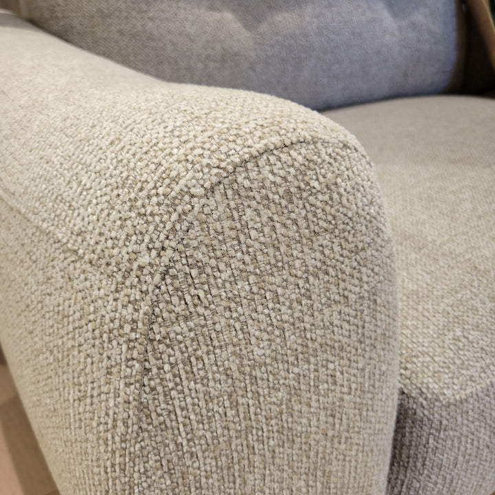 Close-up shot showcasing the texture of a couch's armrest, emphasizing the fabric's weave and color.