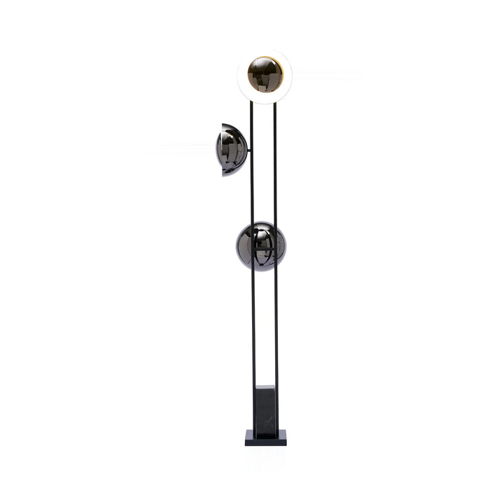 A modern floor lamp with a black frame, a white and gold upper sphere, and two reflective grey spheres, displayed on a white background.