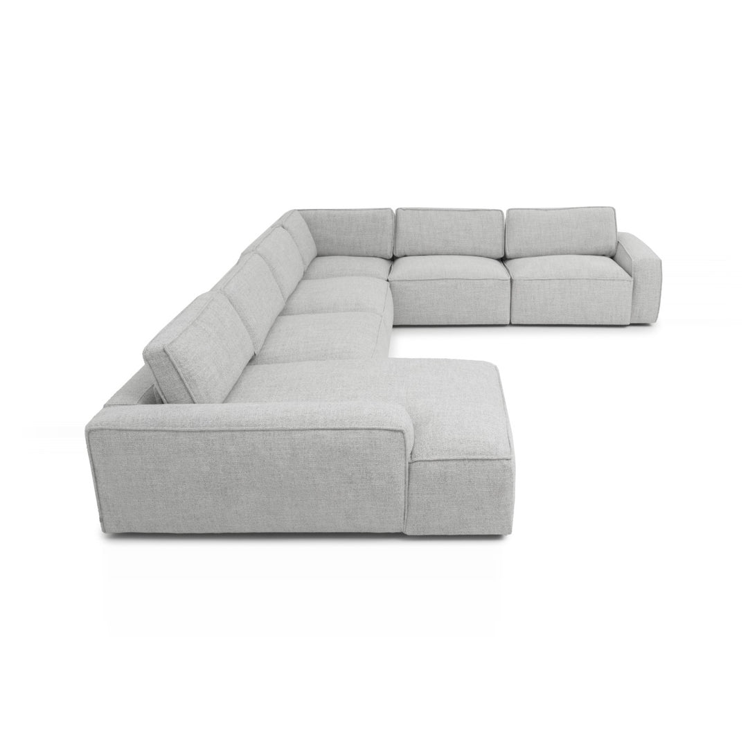 A light gray modular sectional sofa is displayed on a white background, showcasing its shape and design.