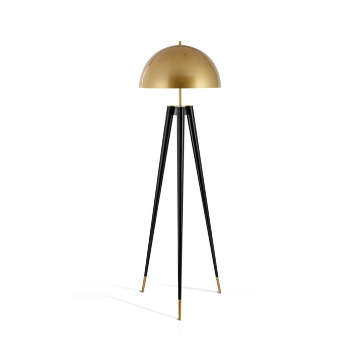 A standing lamp with a gold dome shade and a black tripod base on a white background.