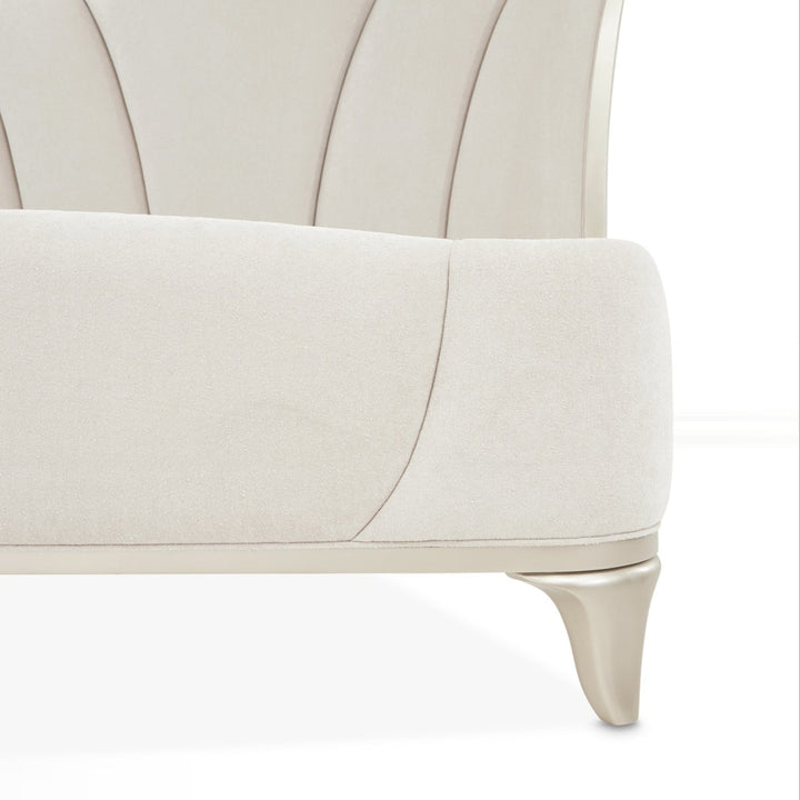 Close-up of furniture on a white background, showcasing the headboard design, upholstery material, and leg detail.