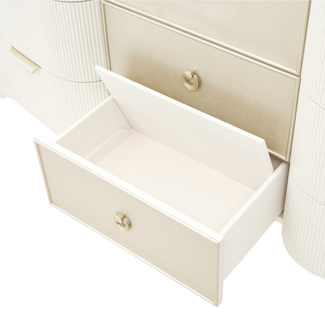 Close-up of a cream-colored dresser with an open drawer against a white background, showing the drawer's interior and hardware.