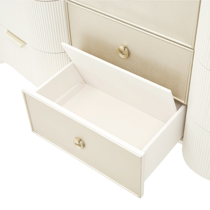 Close-up of a cream-colored dresser with an open drawer against a white background, showing the drawer's interior and hardware.
