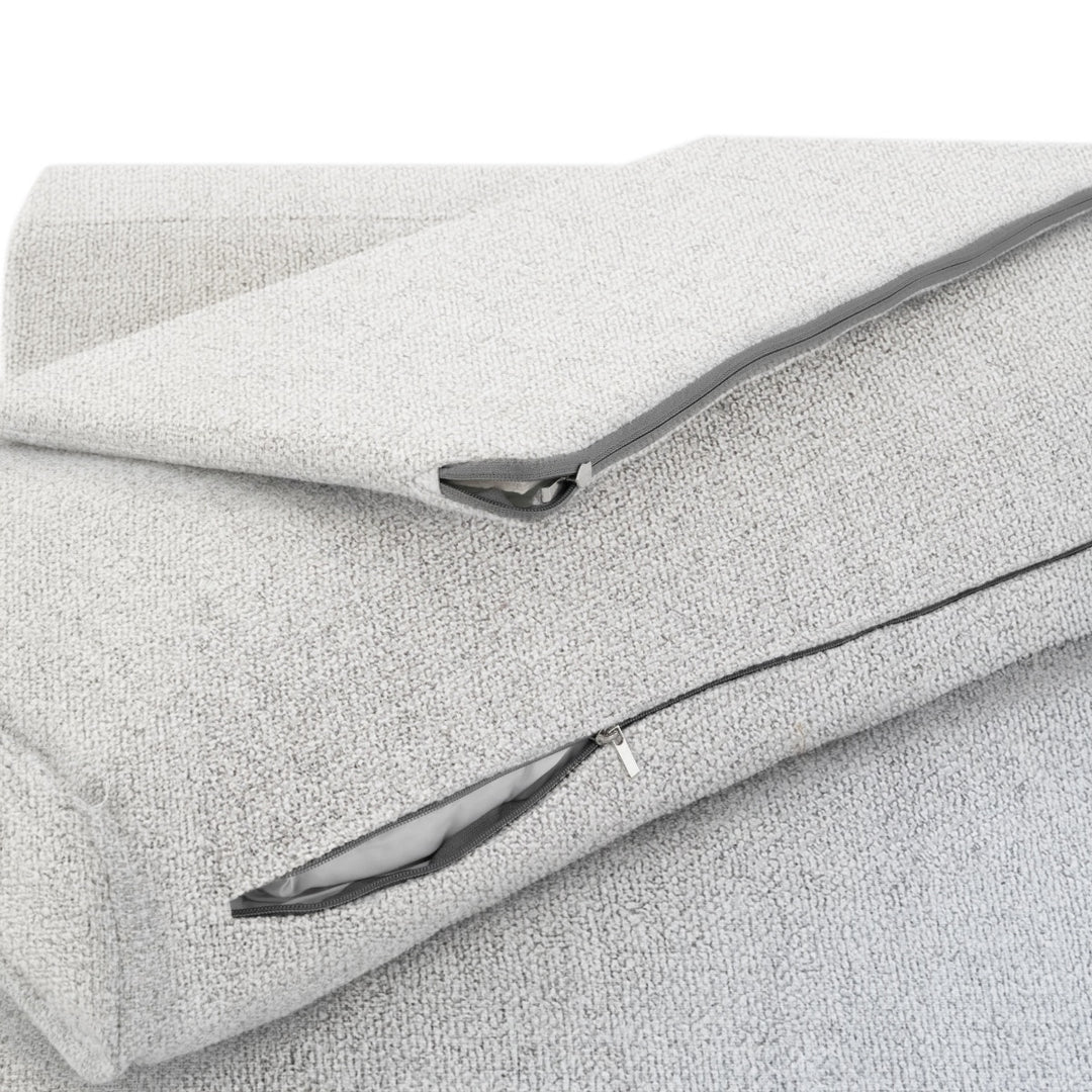 Close up of a light grey fabric with a zipper closure, showcasing the material texture and design detail.