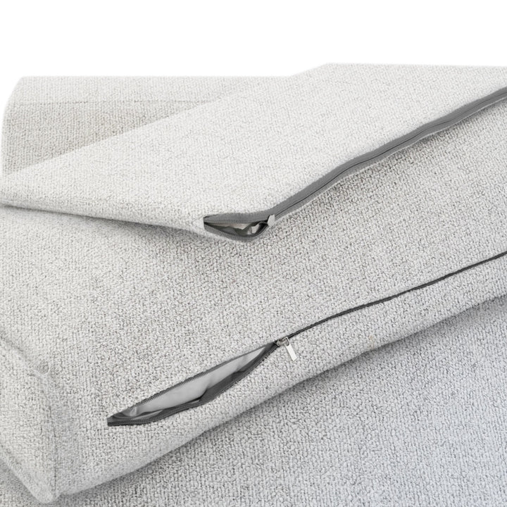 Close up of a light grey fabric with a zipper closure, showcasing the material texture and design detail.