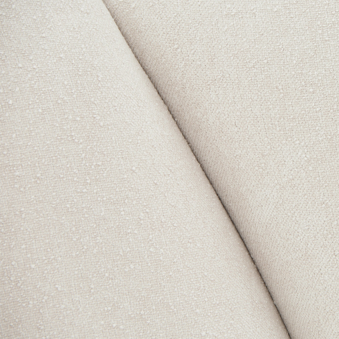 Close-up of a textured off-white fabric, likely upholstery material.