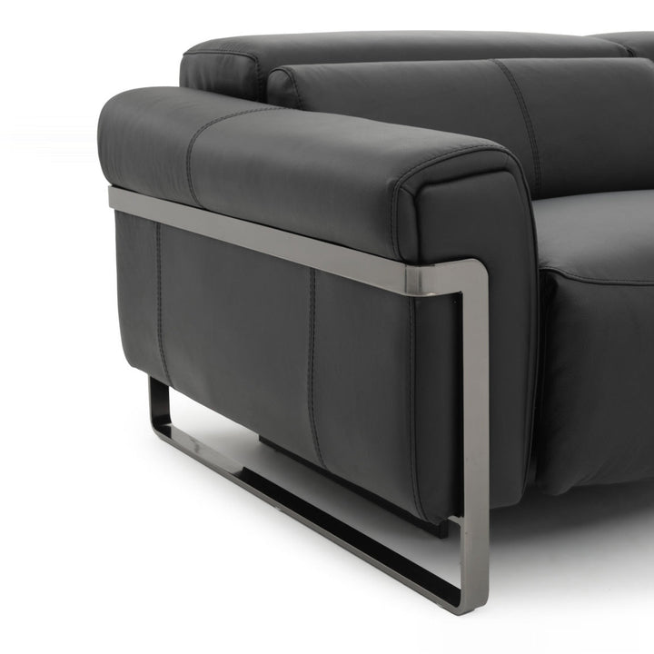 Close-up of a black leather sofa on a white background, showing the armrest and metal frame.