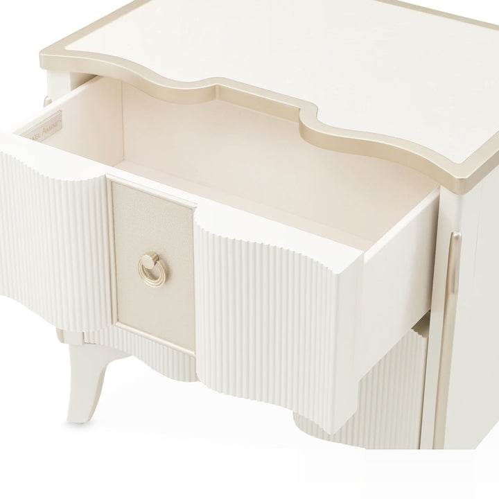 A white and gold nightstand with one drawer open, isolated on a white background.