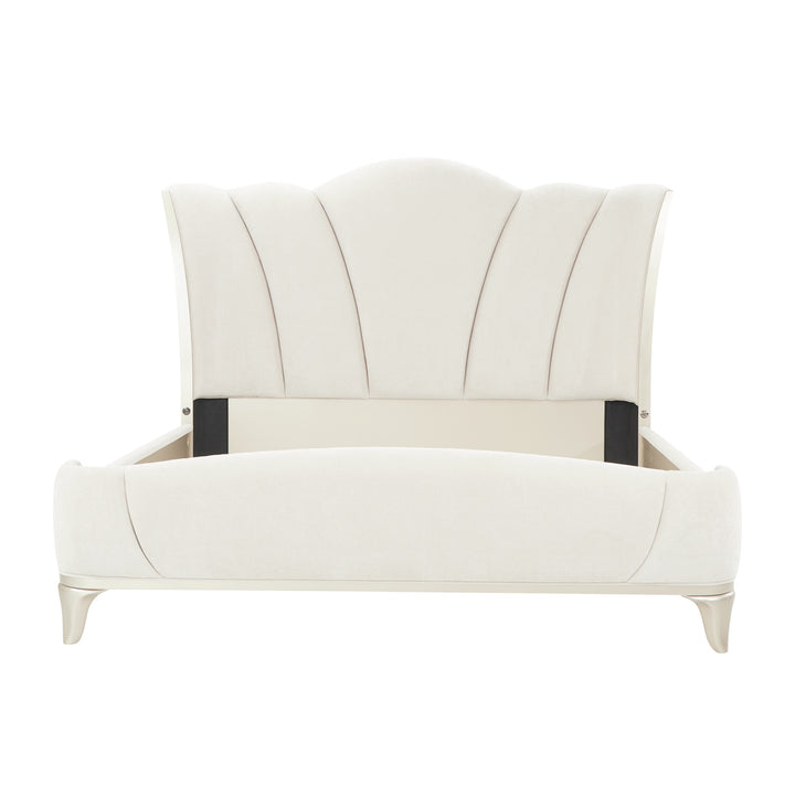 A cream-colored upholstered bed frame with a scalloped headboard, set against a white background.