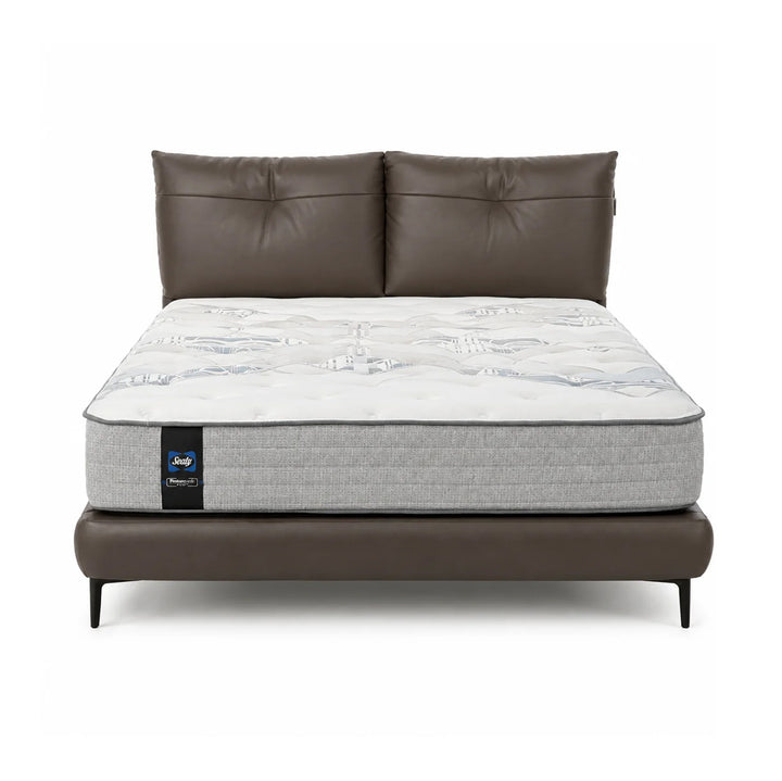 A luxury mattress on a matching brown faux-leather bed frame with a tufted headboard, shown against a solid white background.